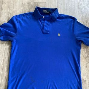 Polo by Ralph Lauren blue. Shirt has some stains. Shown on one of the pictures